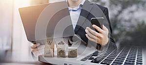 Asian business man and young beautiful woman working on digital tablet computer standing outside office building