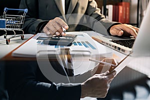 Asian business man and young beautiful woman working on digital tablet computer standing outside office building