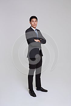 asian business people man good looking in studio. Full length Asian businessman in grey suit confident with crossed arms isolated