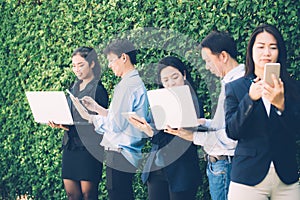 Asian business people meeting corporate digital device connection concept on tree wall