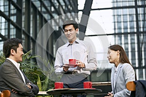 Asian business people meeting in outdoor cafe