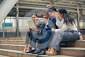 Asian business people raise hands in fists feel excite and happy with their team achievement