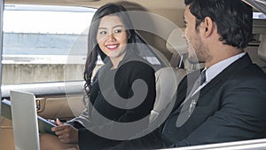Asian business people smart man and woman talk in back seat car during car driving.Business life executive concept