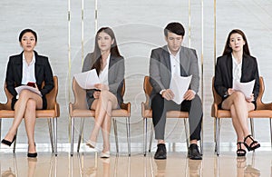 Asian business people are stressed about waiting for a job interview.