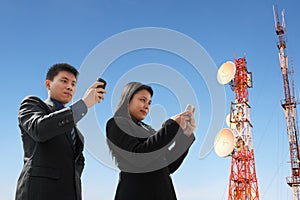 Asian business people texting and antenna