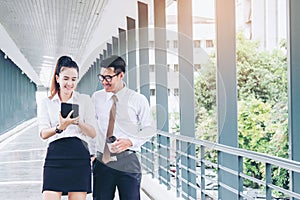 Asian Business people walking and talking outside office.