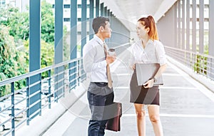 Asian Business people walking and talking outside office.