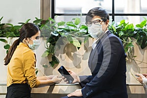 Asian business people with wearing hygienic mask prophylactic manager.