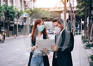 Asian Business People Working and Surveying Outdoor Location for New Business ,They are Wearing Protective Mask to Prevent Flu and