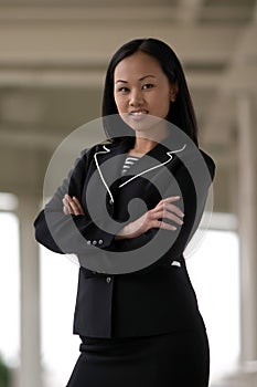 Asian Business Woman with Arms Folded Smiling