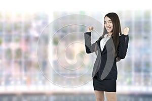 Asian business woman celebrating cheerful for her success on office background.