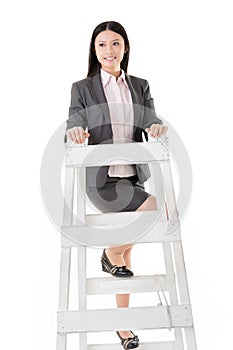 Asian business woman climb a ladder