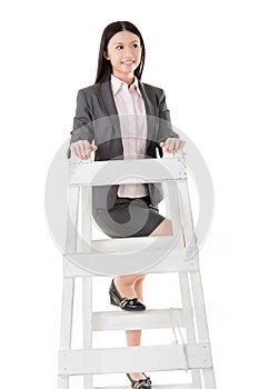 Asian business woman climb a ladder