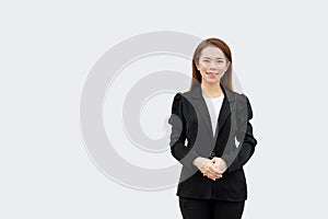 Asian business woman Crossed hands standing with long hair in black suit isolated on white color background