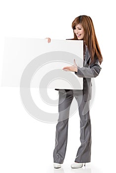 Asian business woman holding a blank board