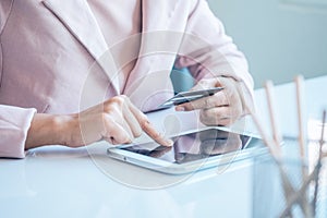 Asian business woman holding a credit card and using laptop for online shopping