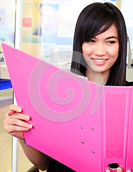 Asian business woman holding document file