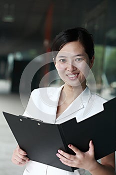 Asian business woman holding with folder