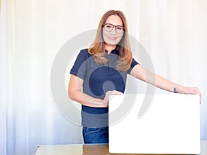 Asian business Woman holding White board in office.
