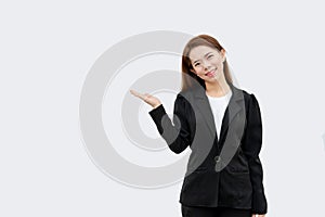 Asian business woman presenting hand with long hair in black suit isolated on white color background