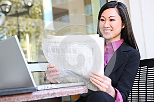 Asian Business Woman Reading Newspaper