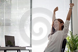 Asian business women are relaxed from working on a white desk in the office photo