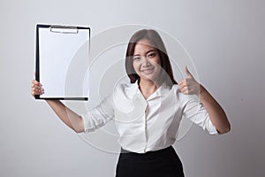 Asian business woman show thumbs up and blank clipboard.