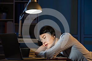 Asian business woman sleepy working overtime late night