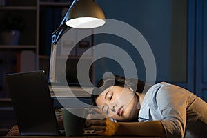 Asian business woman sleepy working overtime late night