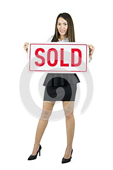 Asian Business woman smiling and holding sold sign. Real estate agent.