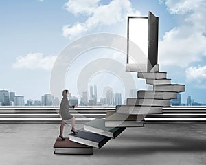 Asian business woman stepping up stair made from book