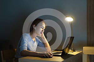 Asian business woman stress out with project business plan on computer laptop or notebook at home office at night. Asian people