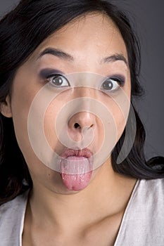 Asian Business Woman in Suit Tongue Out