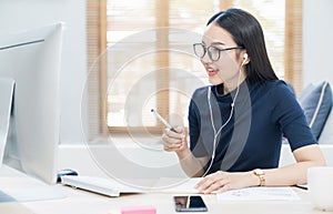 Asian business woman talking to her colleagues about plan in video conference. Business team using computer for a online meeting i