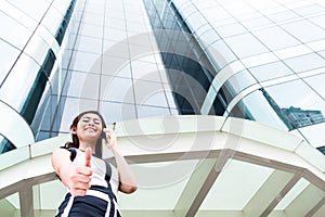 Asian business woman telephoning outside with phone