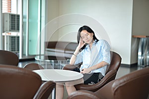 Asian business woman thinking in modern living room