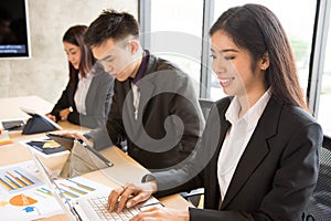 Asian business woman is typing.