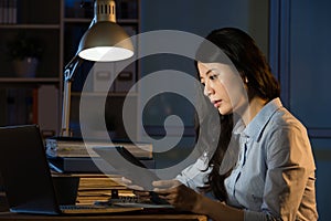 Asian business woman use digital tablet working late overtime