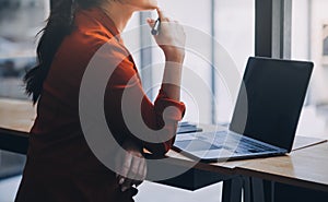 Asian Business woman using calculator and laptop for doing math finance on an office desk, tax, report, accounting, statistics,