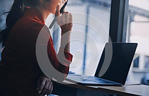 Asian Business woman using calculator and laptop for doing math finance on an office desk, tax, report, accounting, statistics,