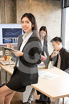 Asian business woman is using tablet.