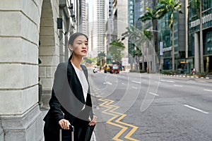 Asian business woman waiting for taxi cab