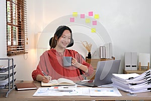Asian business woman working in in coffee shop cafe with laptop paper work, Business woman concept.