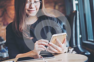 Asian business woman working , holding notebook and using calculator in office