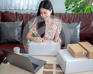 Asian business woman working in home office and delivery her product in online shopping app