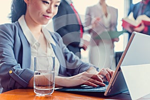 Asian business woman working on laptop