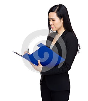 Asian business woman write on clipboard