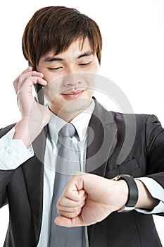 Asian businessman checking time