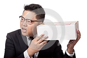 Asian businessman is curious what inside a box