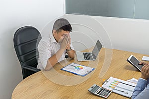 Asian businessman depressed with bad financial situation of the company